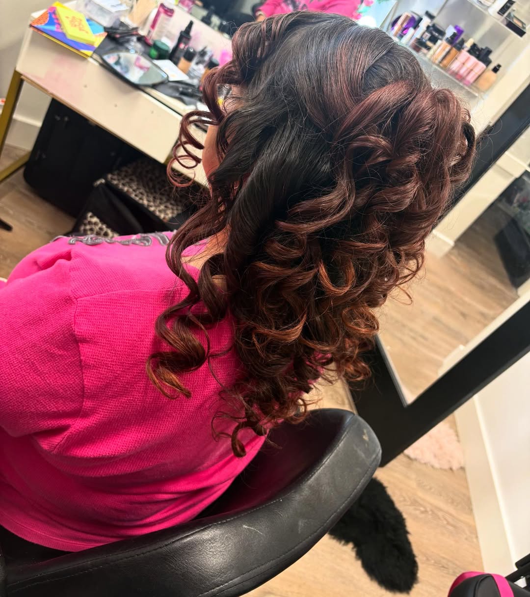 Voluminous burgundy curls styled by MakeupByGen for a quinceañera client