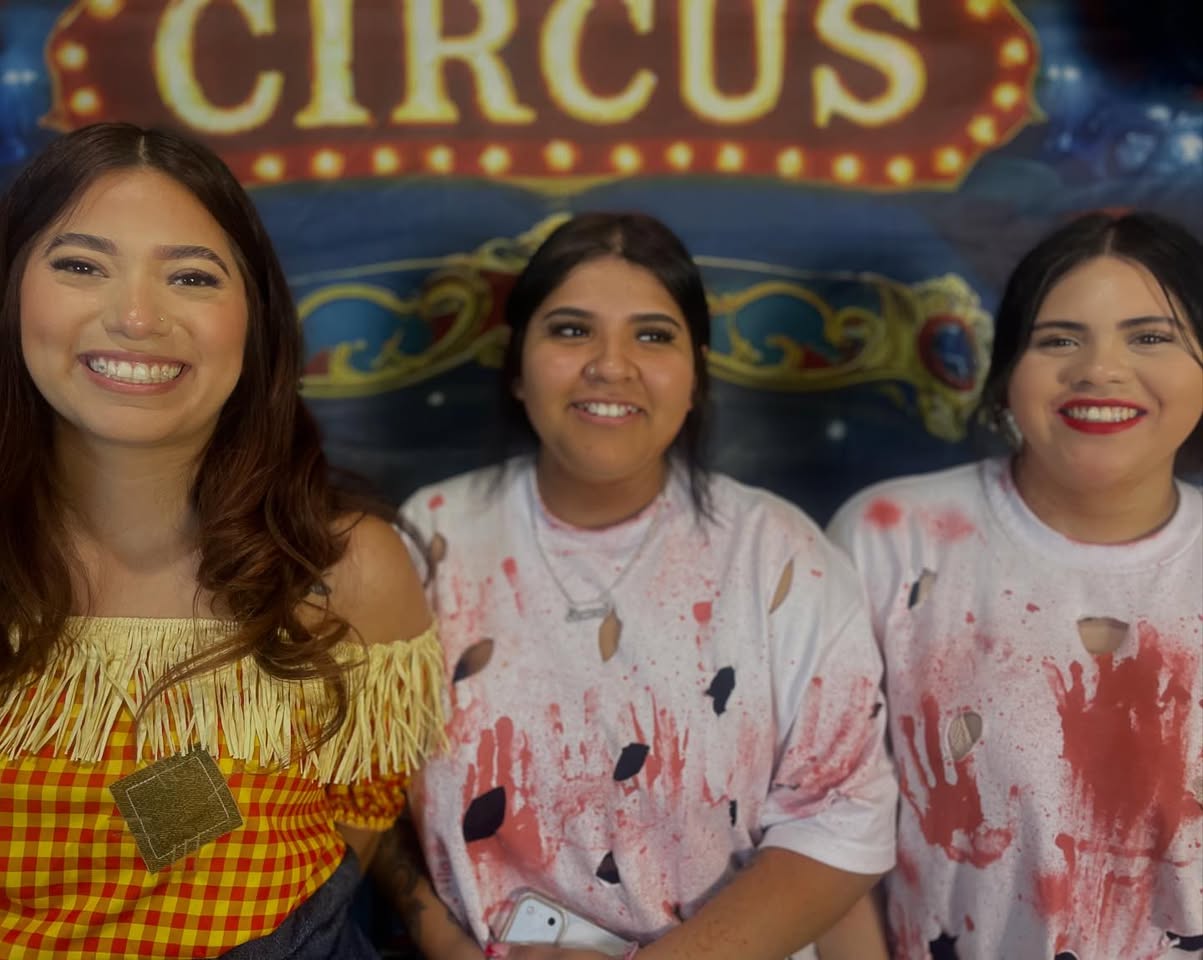 Group of friends smiling with matching tooth gems by MakeupByGen booth